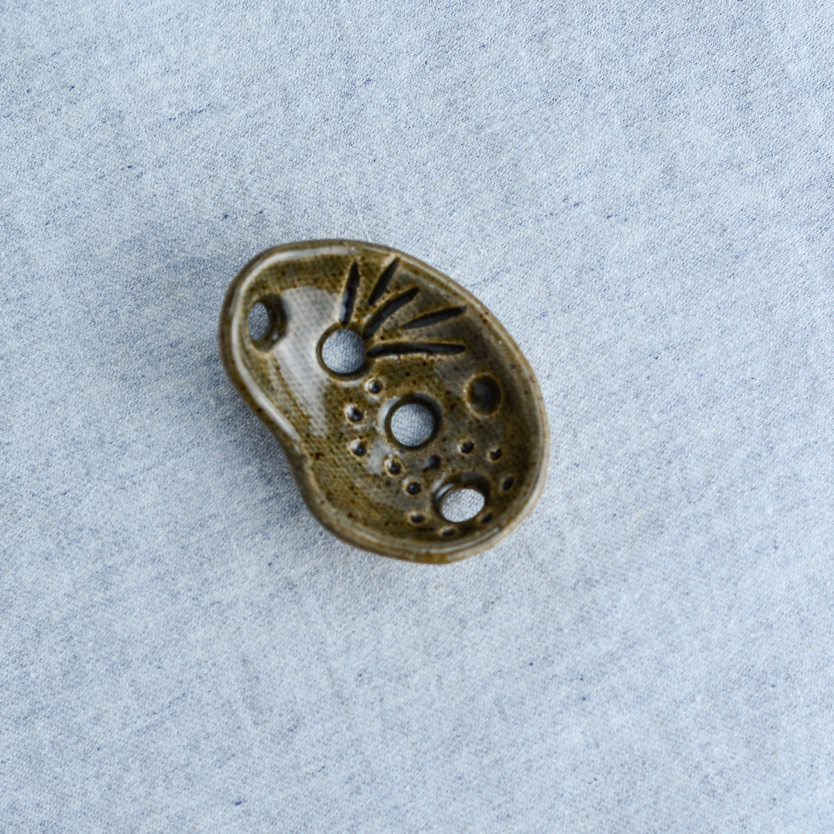 Miniature ceramic sculpture, curved for use as a handheld worry stone
