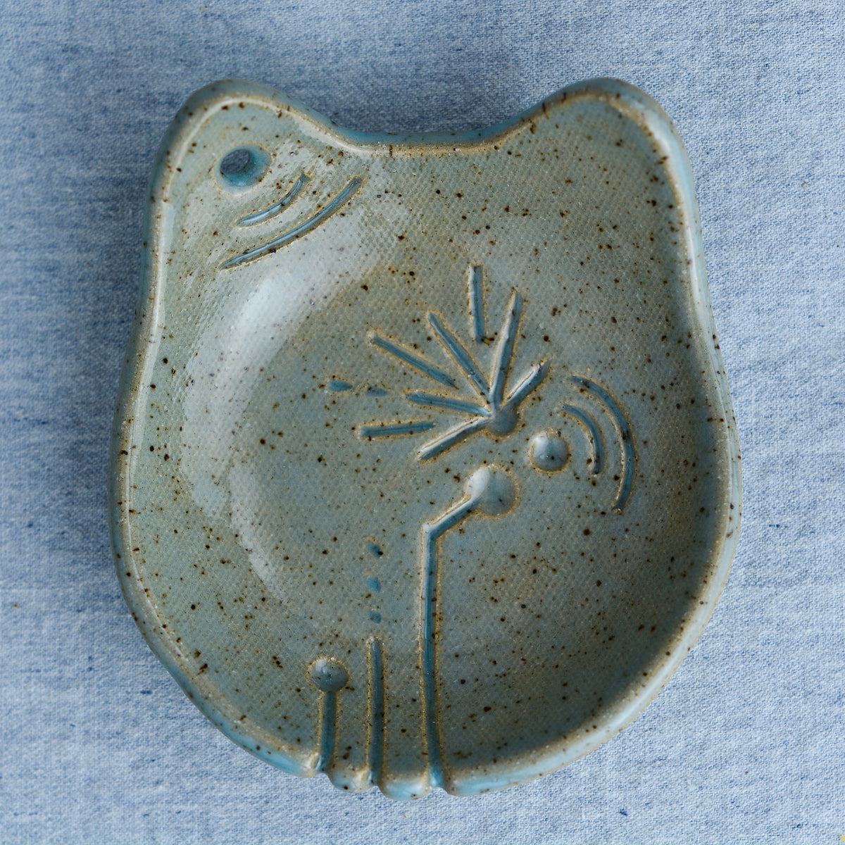 Ceramic cat-shaped dish with an intricate, organic, hand-carved abstract pattern