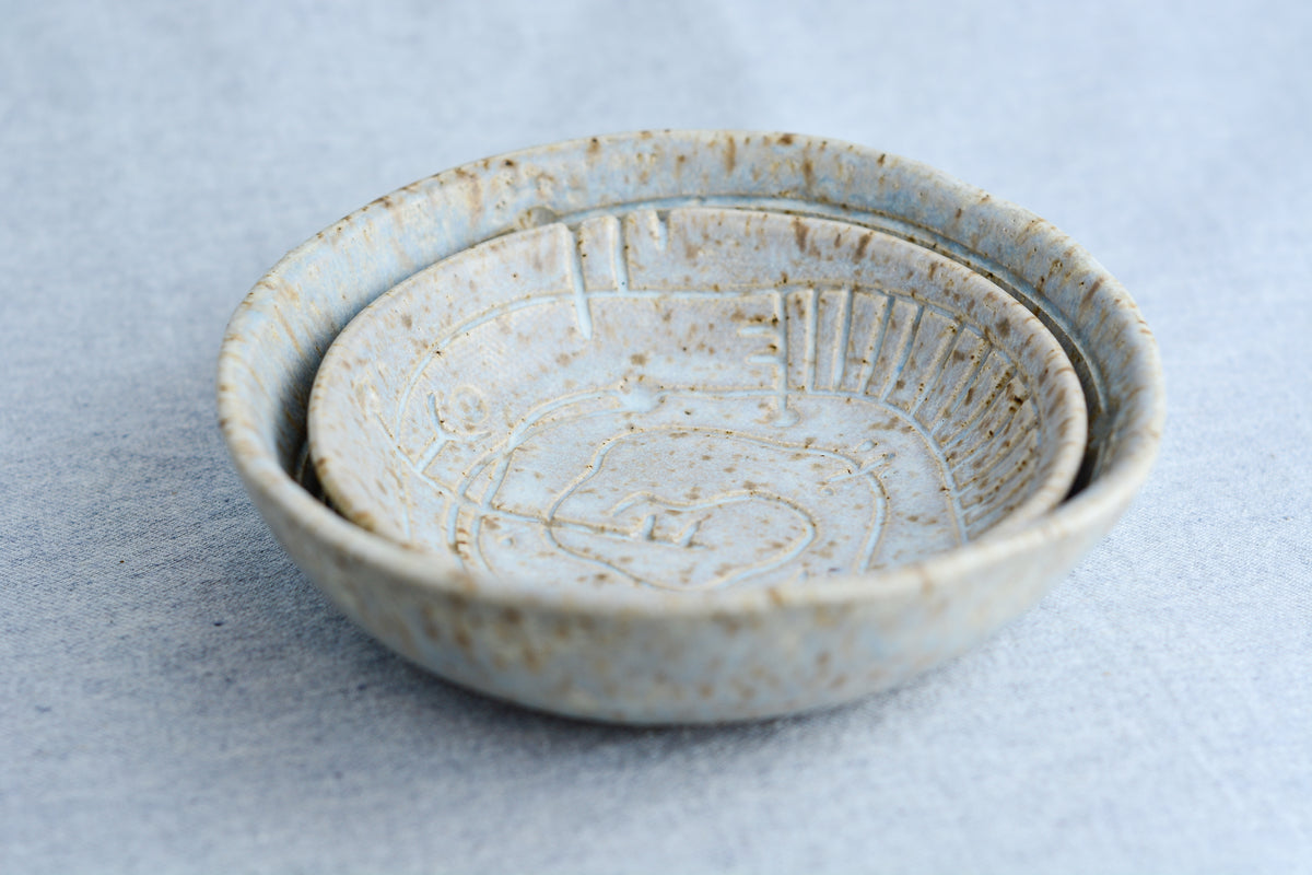 Handmade ceramic bowl with carvings inspired by ancient symbolic languages, musical tablature, and sacred geometry