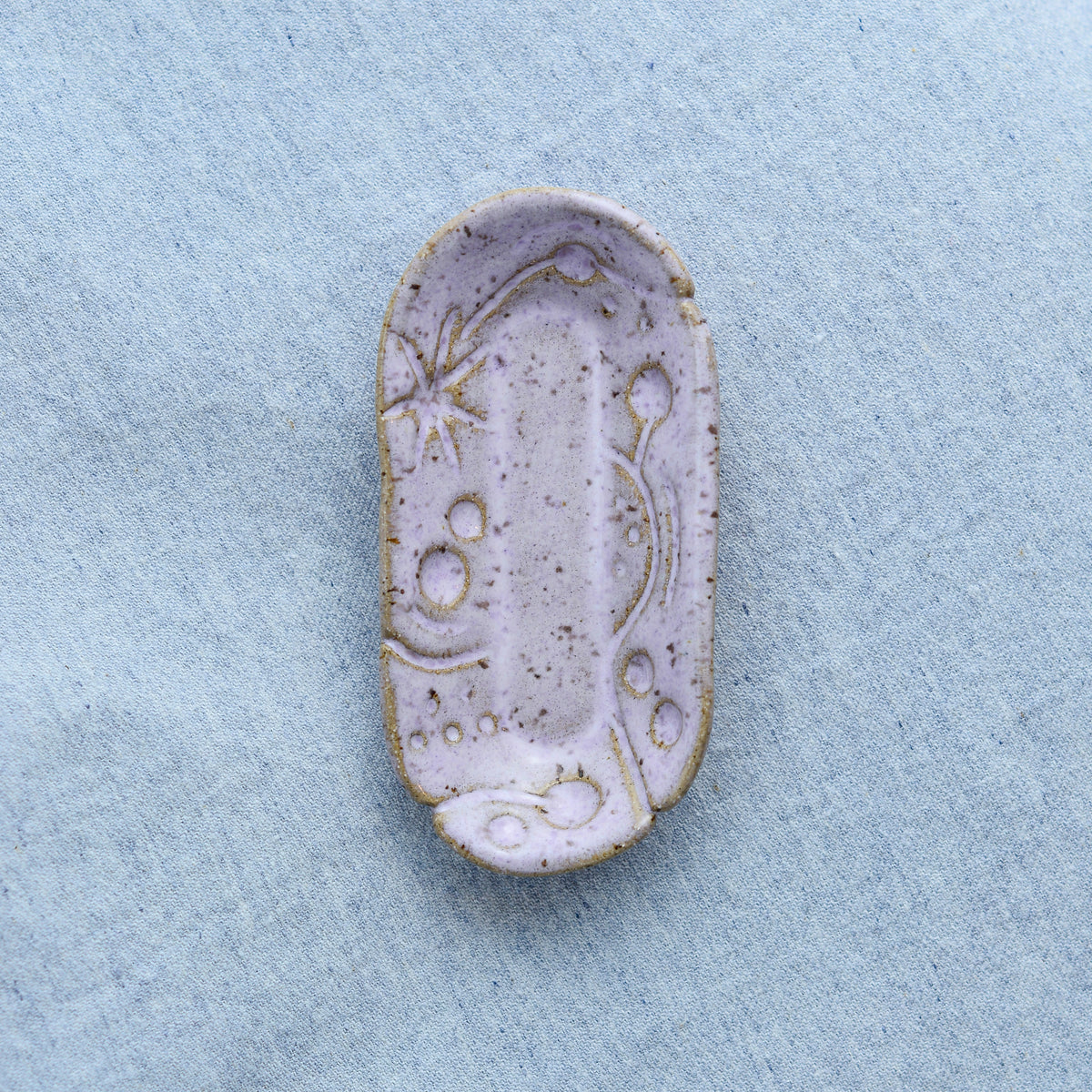 A smaller oblong dish, ideal for holding rings, keys, or a splash of soy sauce. Each piece is unique, showcasing a distinctive hand-carved motif and a matching hand-painted finish.
