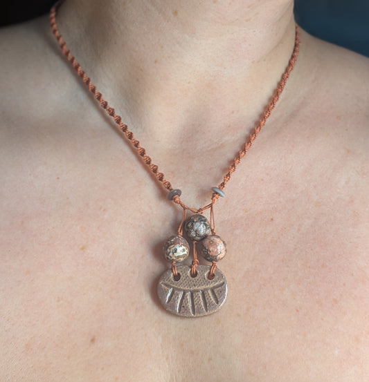 Necklace with a pendant on a person's neck