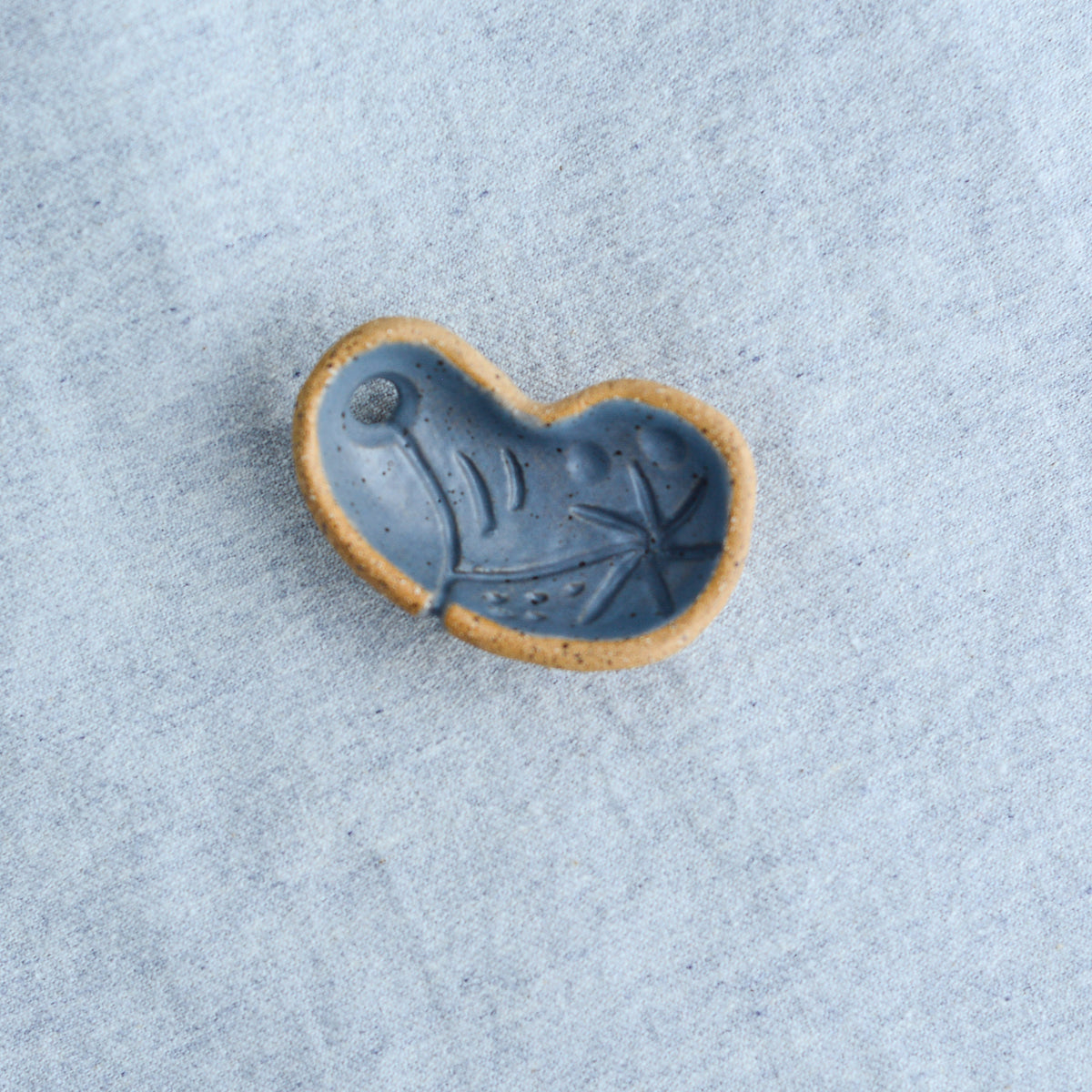 Miniature ceramic sculpture, curved for use as a handheld worry stone