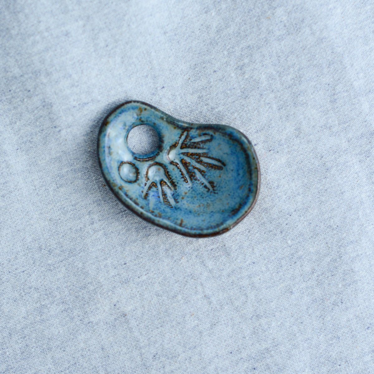 Miniature ceramic sculpture, curved for use as a handheld worry stone