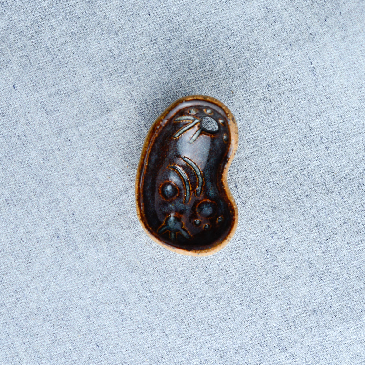 Miniature ceramic sculpture, curved for use as a handheld worry stone