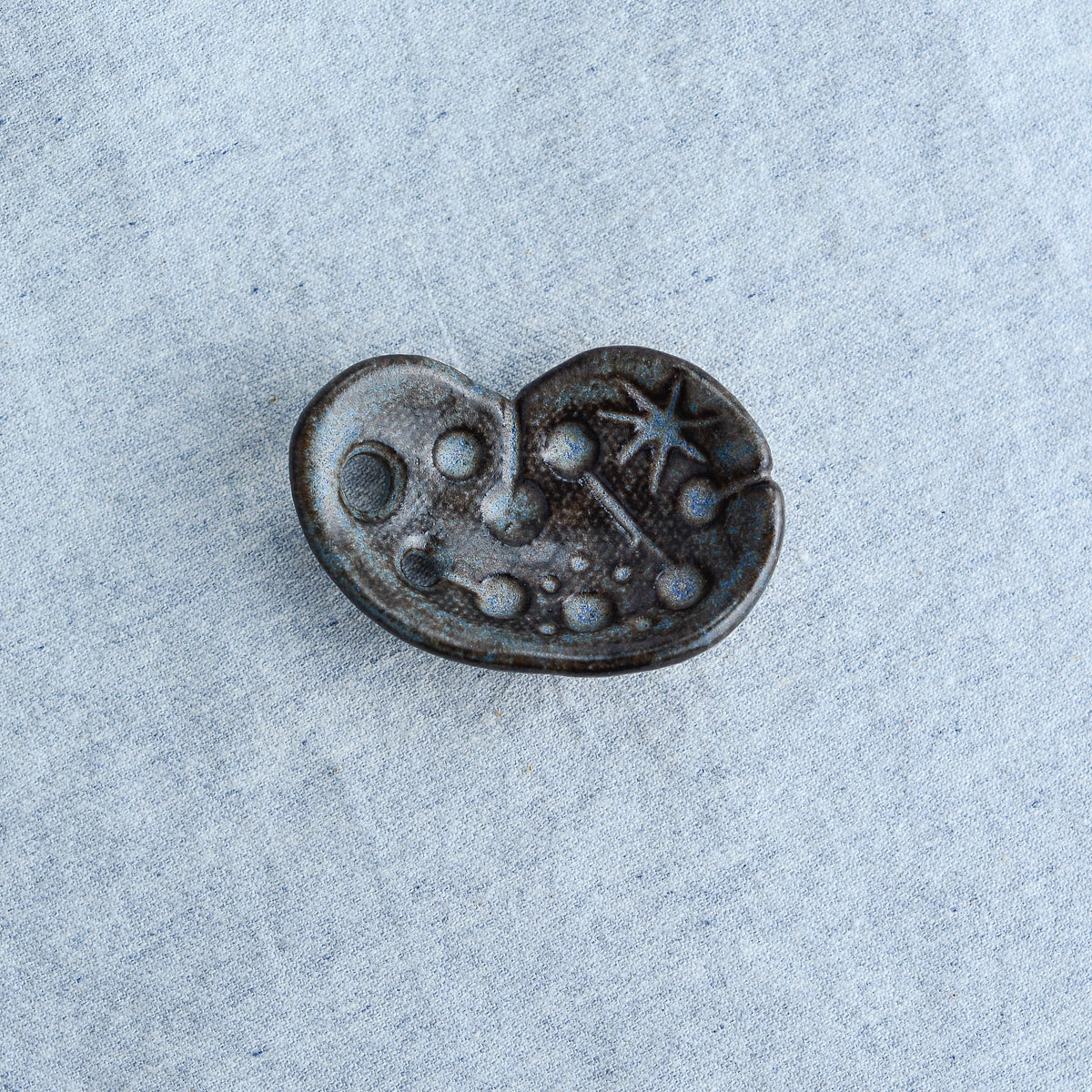 Miniature ceramic sculpture, curved for use as a handheld worry stone