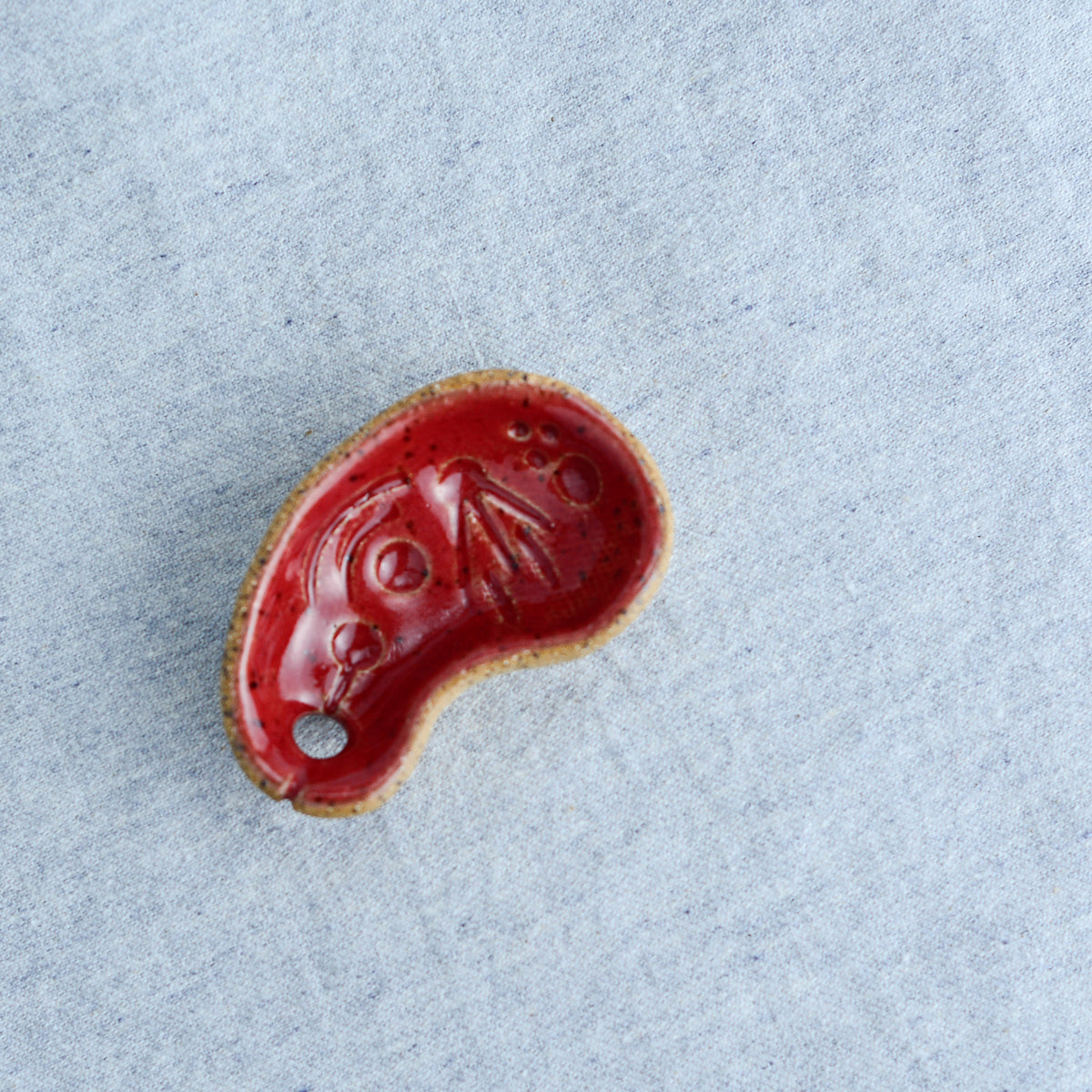 Miniature ceramic sculpture, curved for use as a handheld worry stone