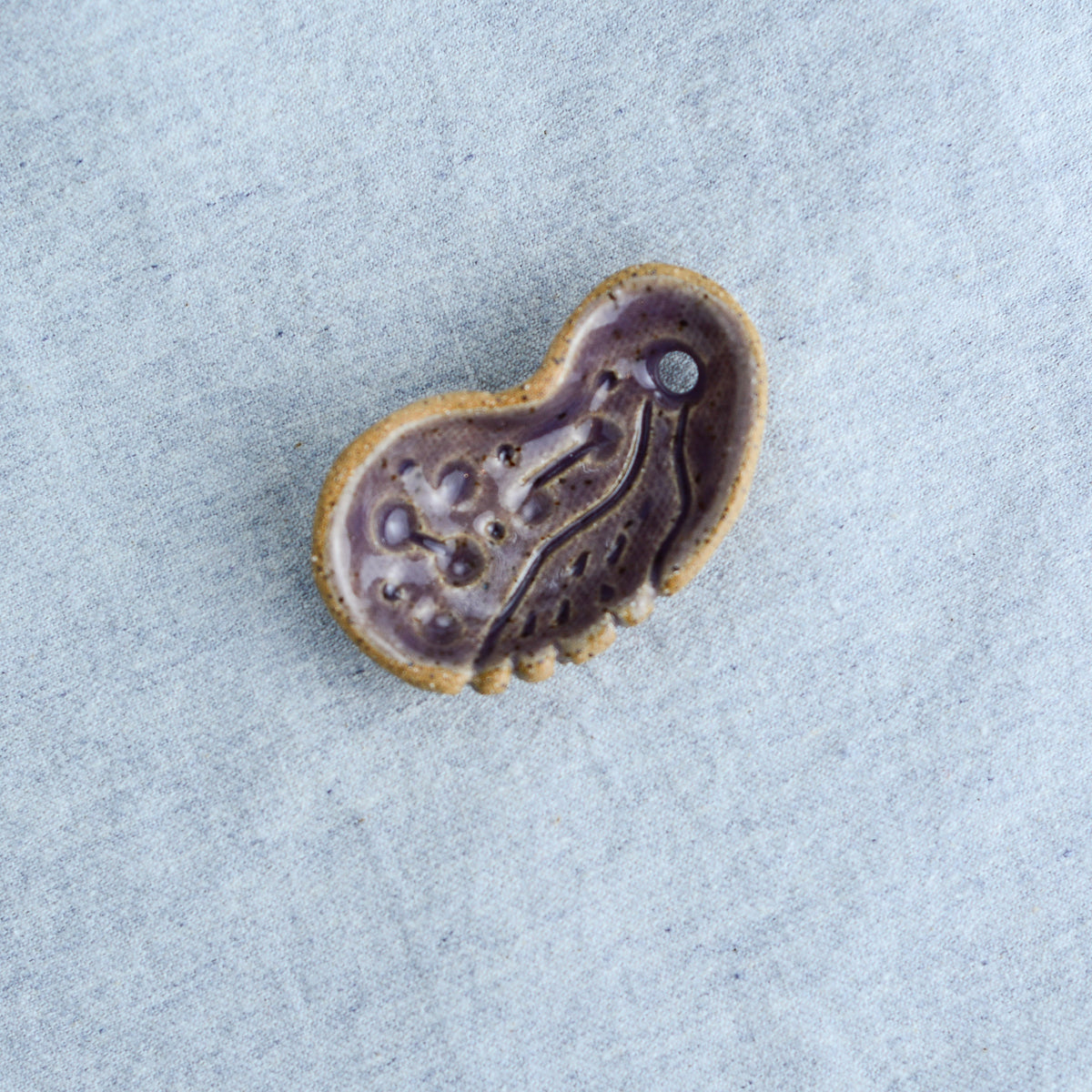 Miniature ceramic sculpture, curved for use as a handheld worry stone