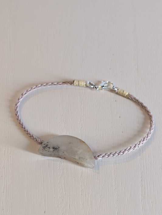 Bracelet with a natural stone on a light background