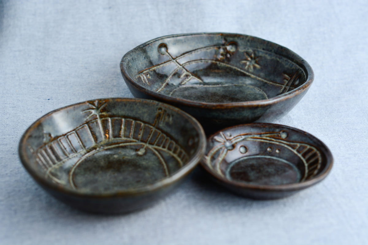 Handmade ceramic bowl with carvings inspired by ancient symbolic languages, musical tablature, and sacred geometry