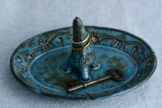 Ceramic ring tray featuring a tiny dinoasur-like creature; created with a mix of sculpture, slab work, and surface design