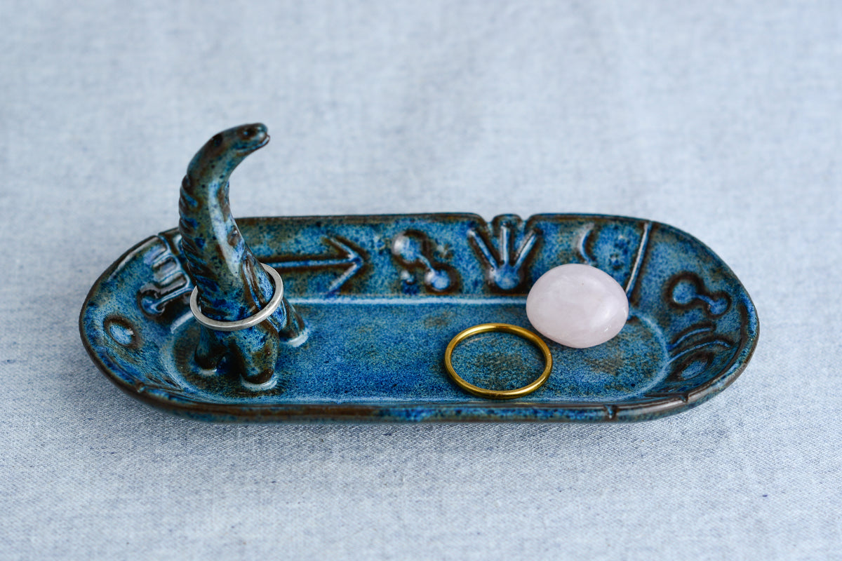 Ceramic ring tray featuring a tiny dinoasur-like creature; created with a mix of sculpture, slab work, and surface design