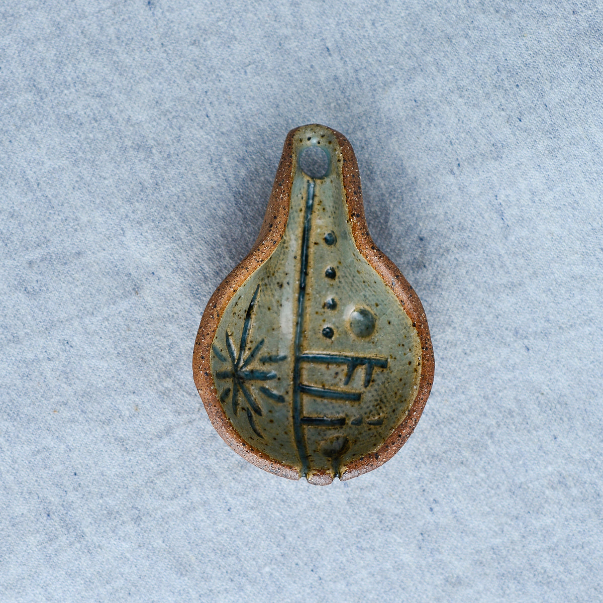 Palm-size sculpture for scooping out coffee grounds, tea leaves, or a simple bowl of soup
