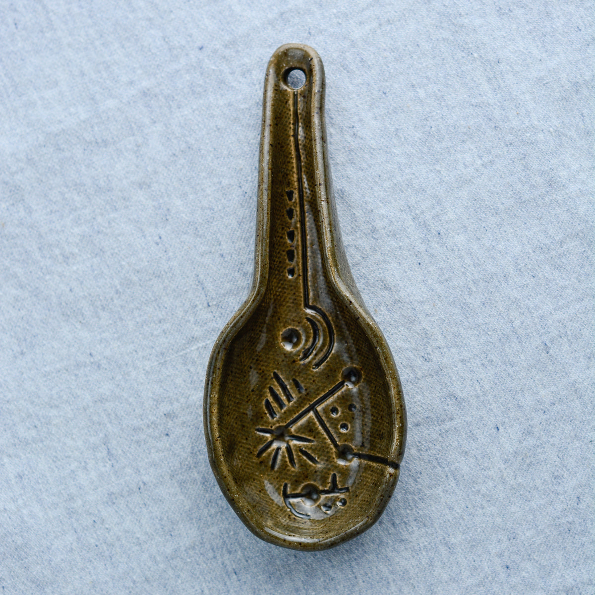Palm-size sculpture for scooping out coffee grounds, tea leaves, or a simple bowl of soup