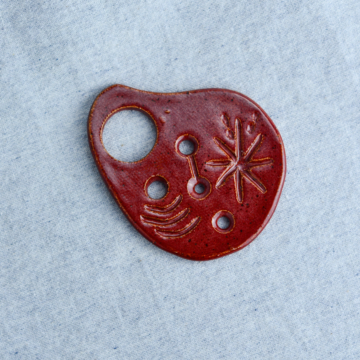 Hand carved and perfectly palm-sized. Feed tough herb stems through the holes to strip off the tender leaves