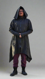 Knee-length heathered charcoal grey ponte knit hooded coat with two way zippered front and thumbholes for the hands. Masc presenting model.