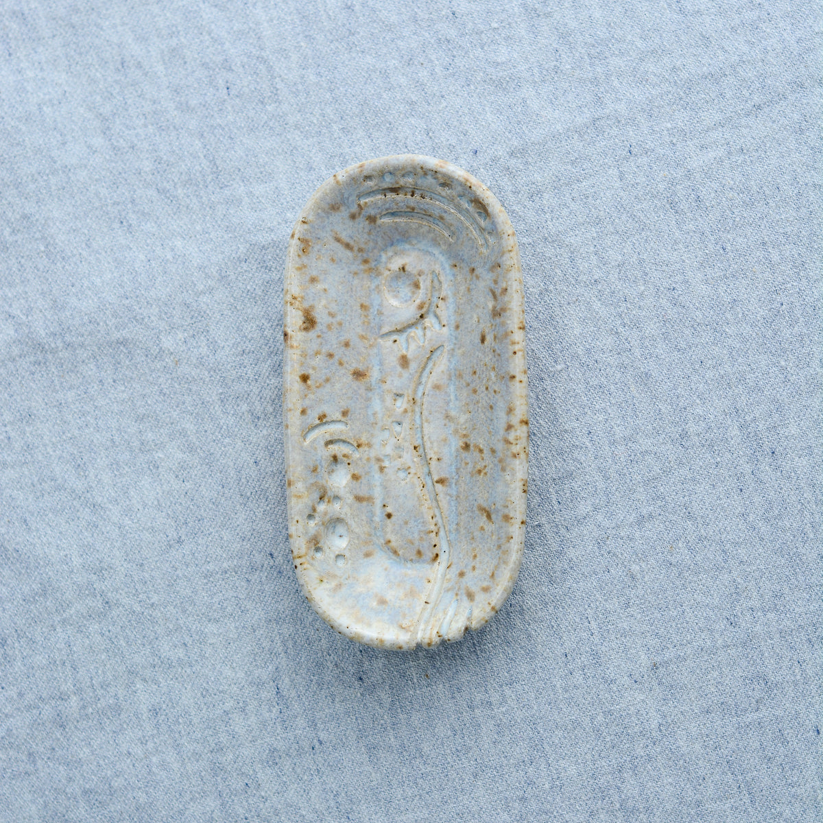 A smaller oblong dish, ideal for holding rings, keys, or a splash of soy sauce. Each piece is unique, showcasing a distinctive hand-carved motif and a matching hand-painted finish.