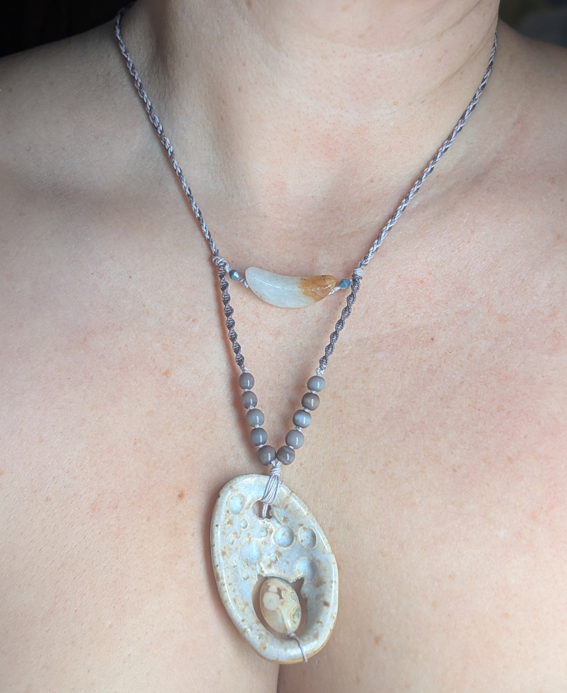 Necklace with a large pendant worn by a person
