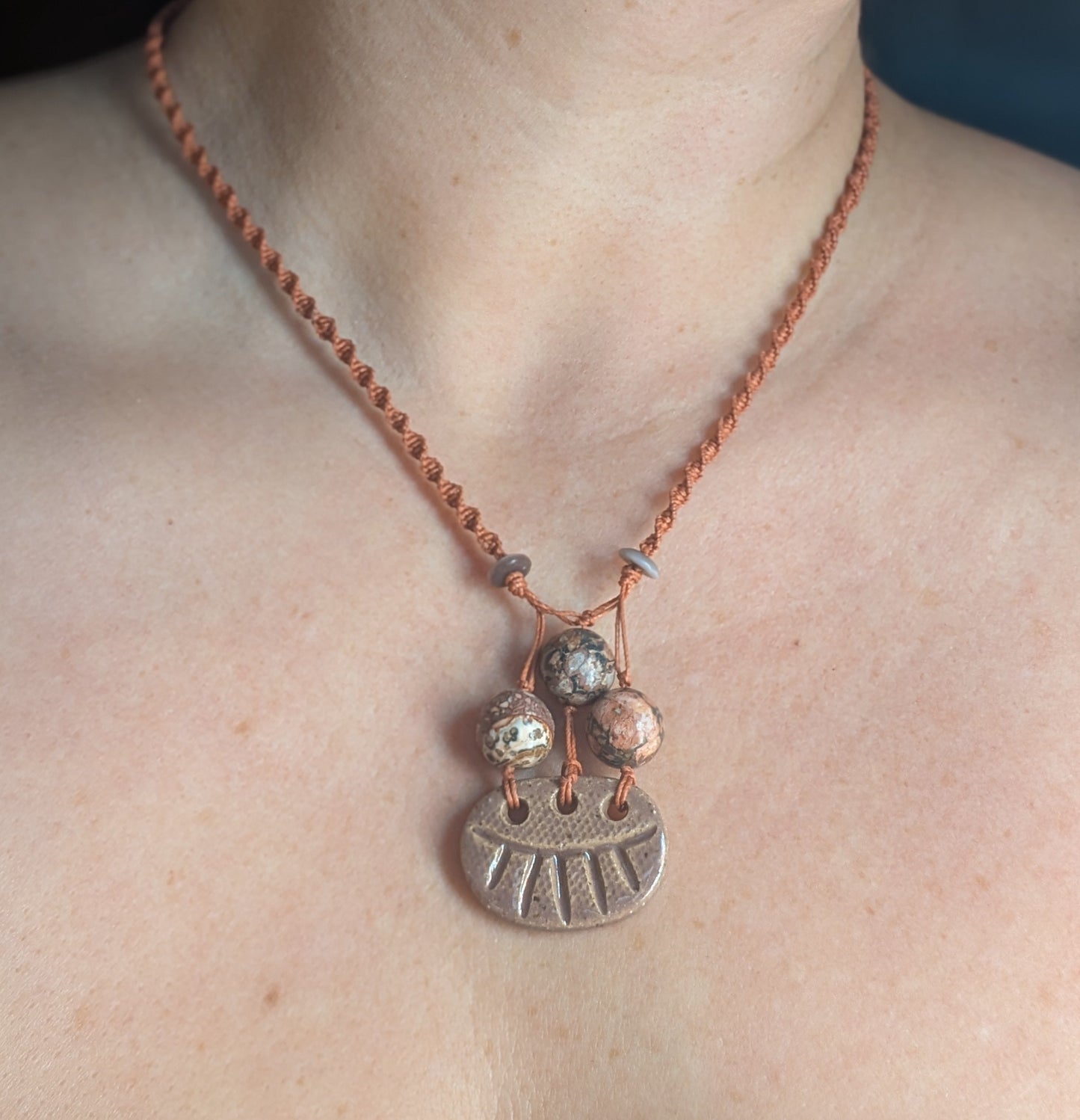 Necklace with a pendant on a person's neck