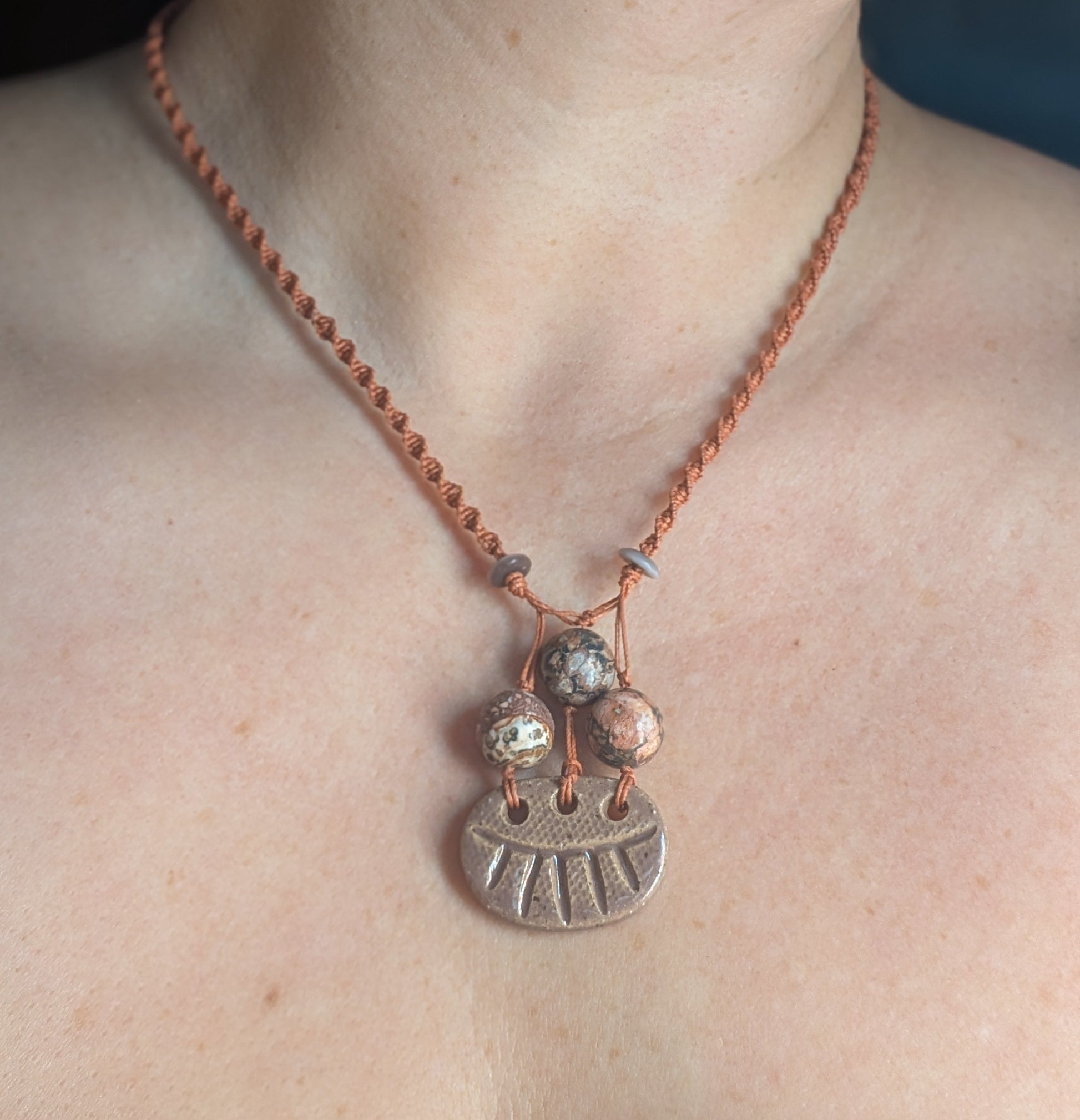 Necklace with a pendant on a person's neck