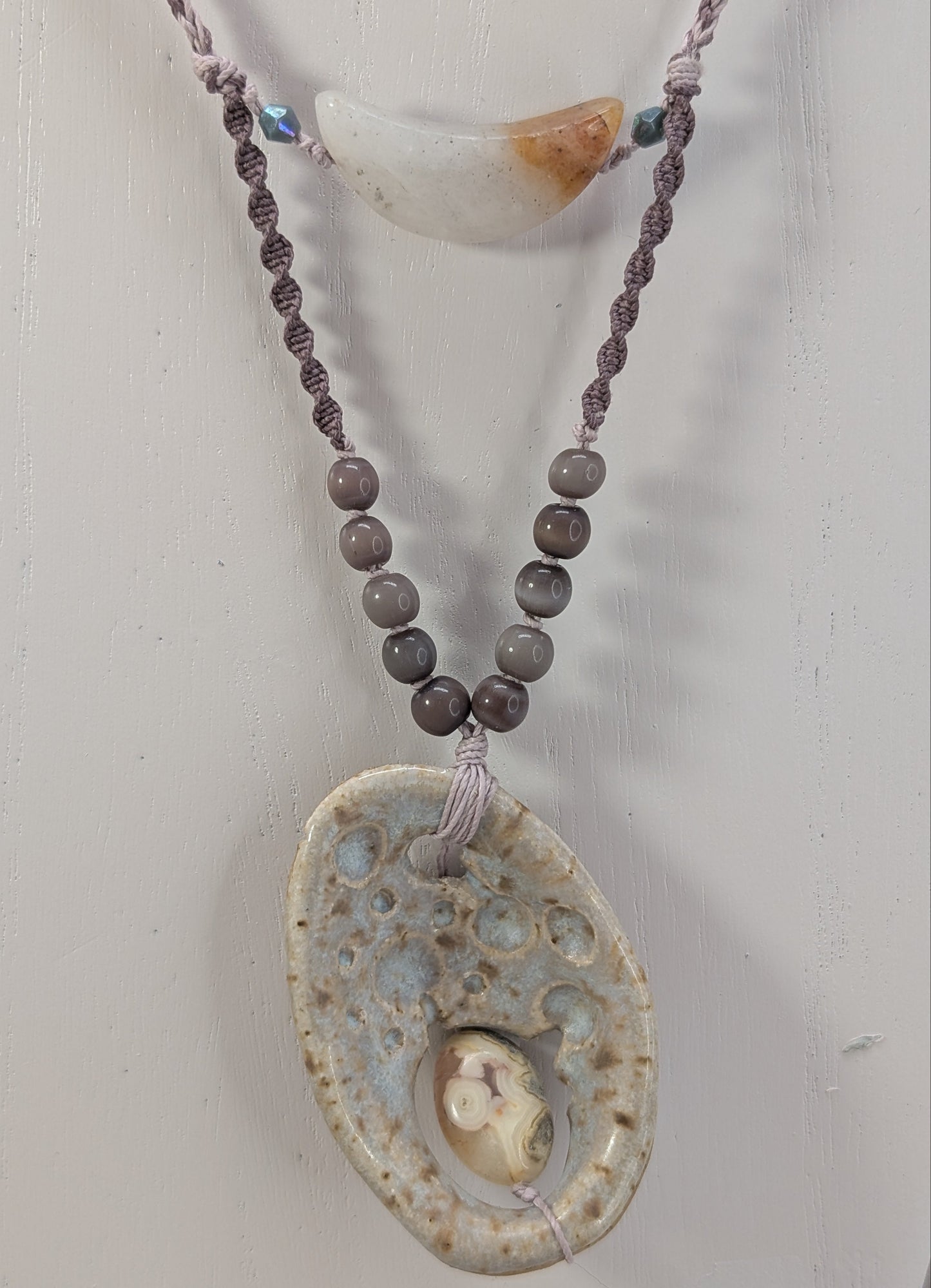 Necklace with a large decorative pendant on a white background