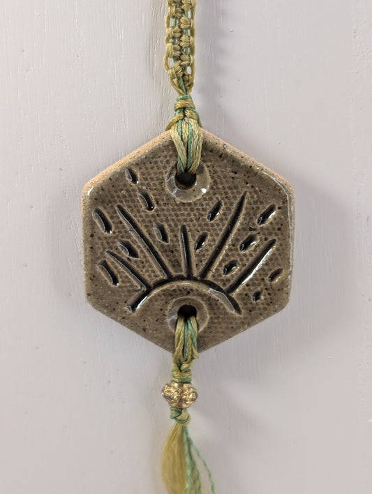 Decorative pendant with geometric design on a white background