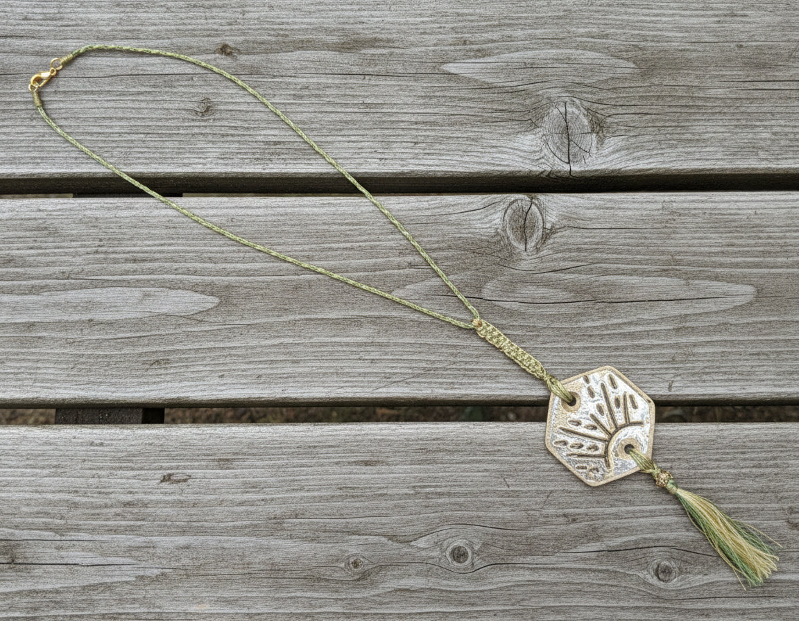 Decorative pendant with a tassel on a textured surface