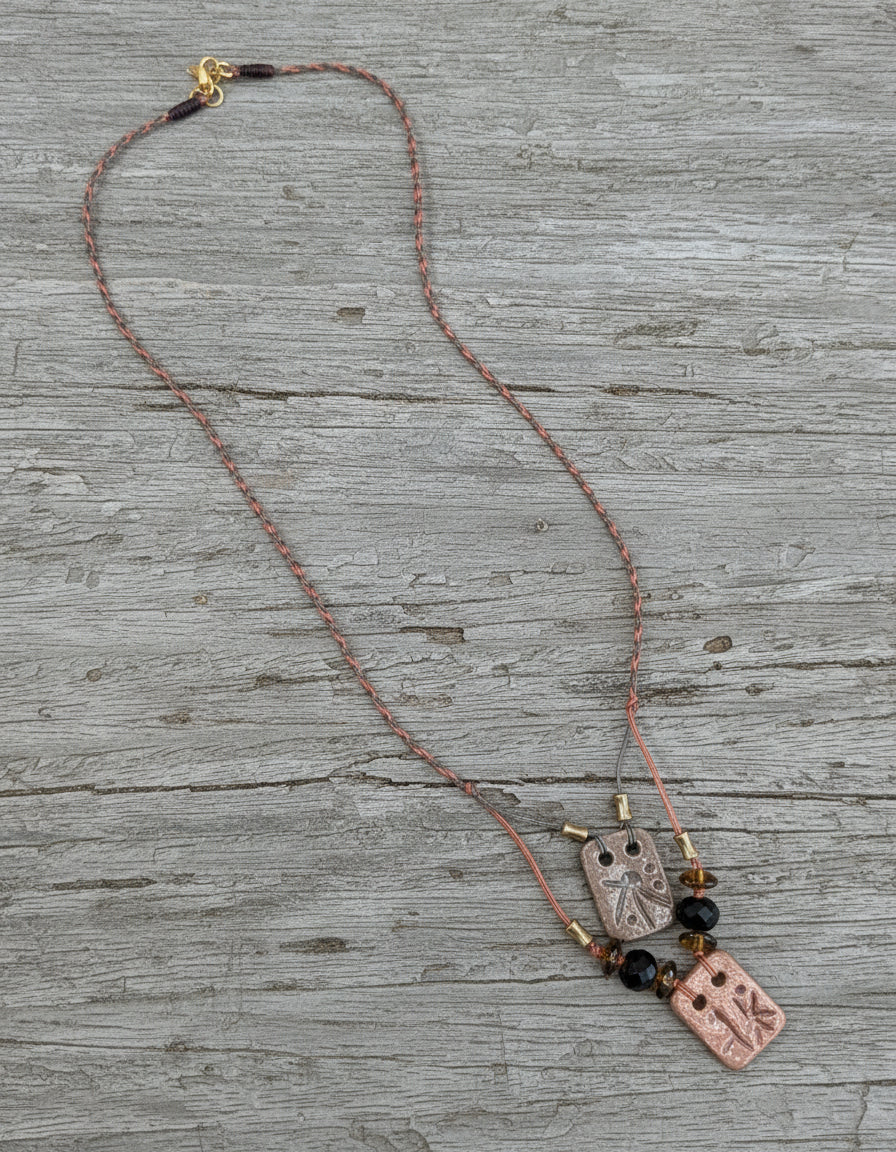 Necklace with rectangular pendants on a light gray background