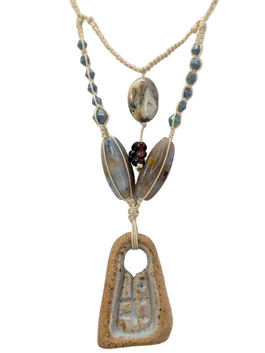 micro macrame hand knotted necklace with glass and stone beads and a hand carved ceramic focal