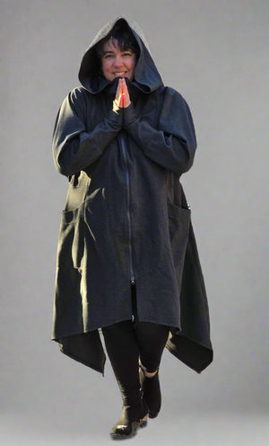 A person wearing a knee length dark grey zip front hooded coat