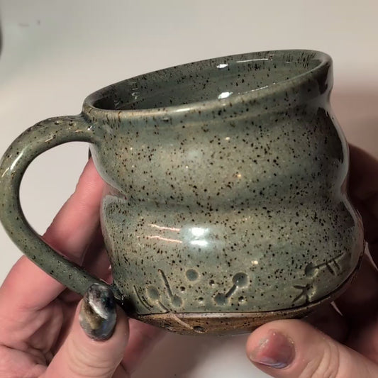 video of a mug being turned over in a hand
