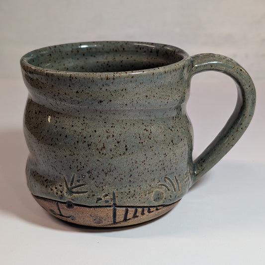 hand carved ceramic mug with sage green freckle glaze