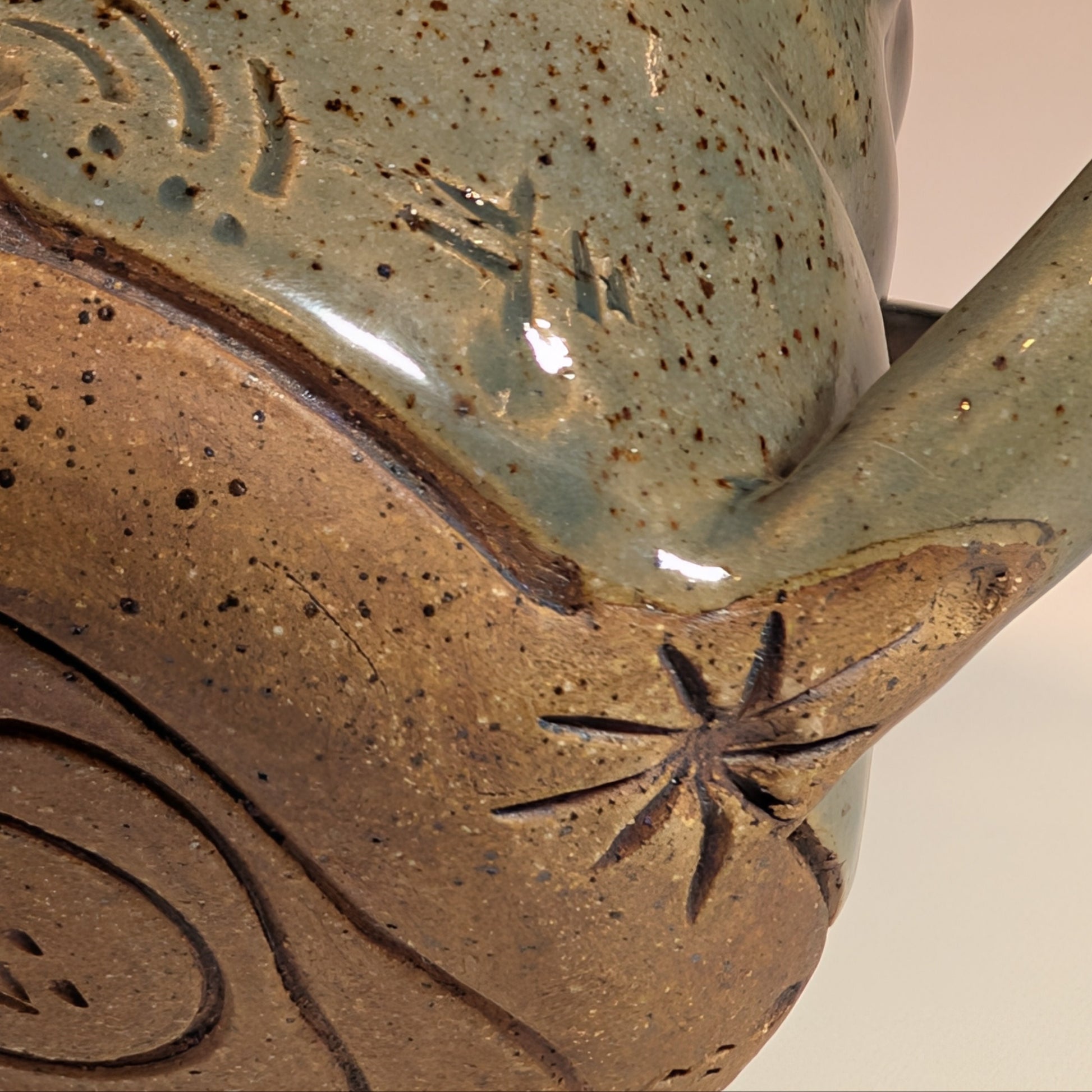 Close-up of a ceramic mug with textured surface and star design.